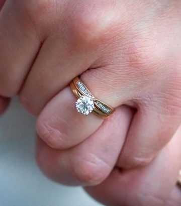 engagement rings on couple's hands